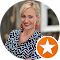 A small, low-resolution profile photo shows a smiling woman with dark hair, overlaid with a small orange star icon typical of a review platform, on the Off Leash K9 Training Springfield, MO site.